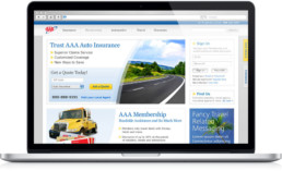 AAA homepage user experience and brand design on a laptop.